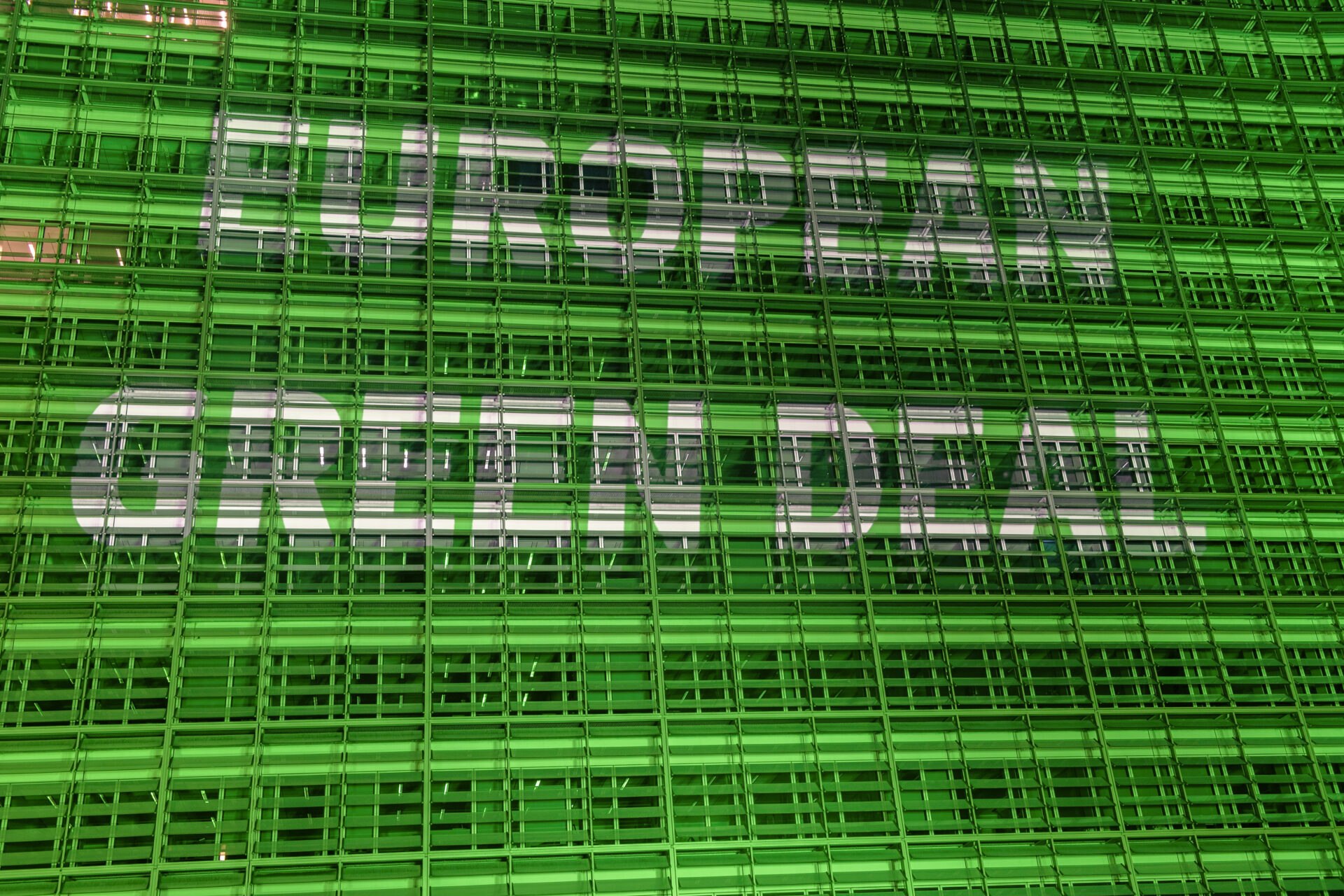 The Berlaymont building lit in green to mark European Green Deal