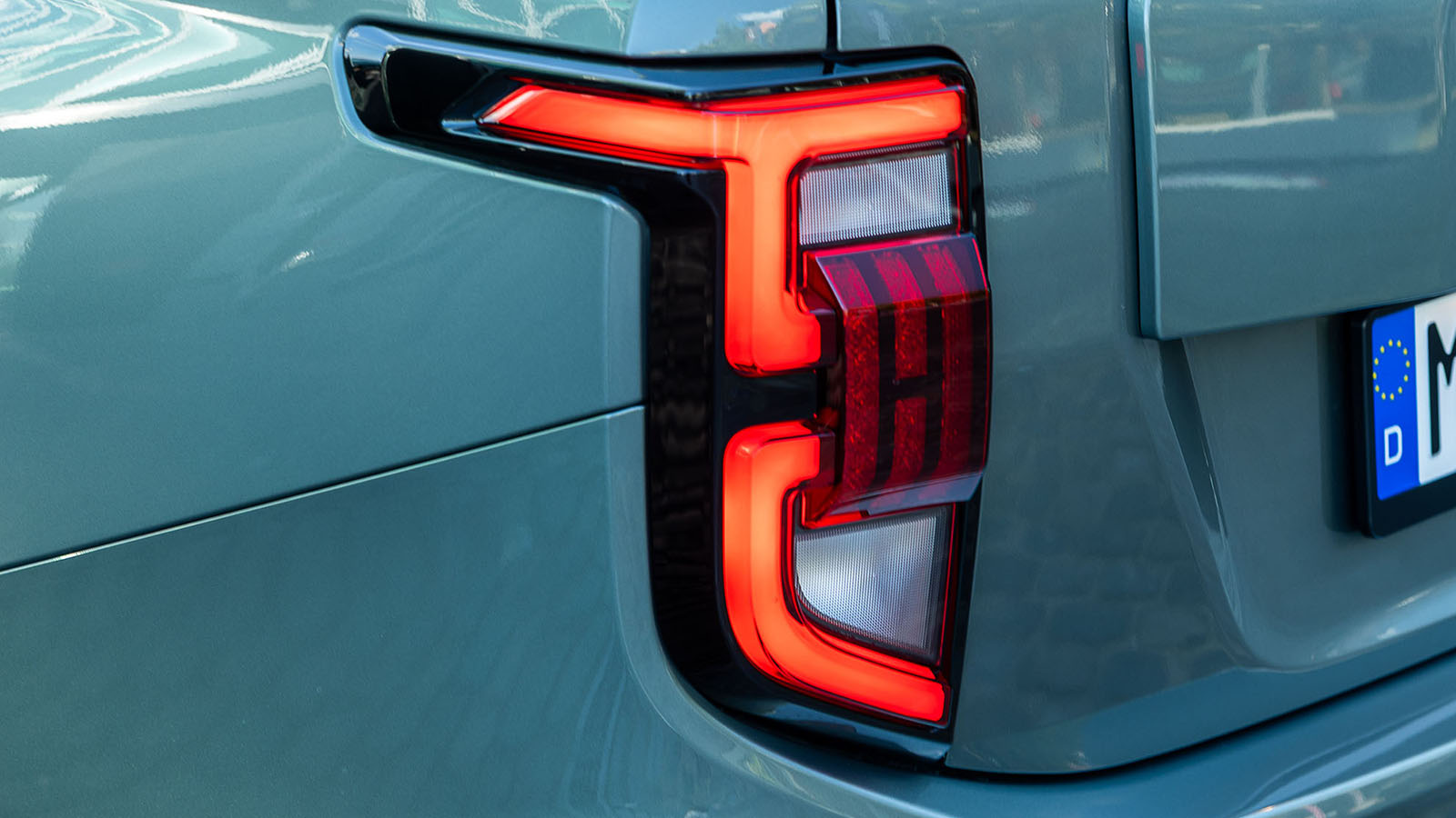 La luz trasera es un guiño a la bandera de Corea del Sur.  - KGM /></p><p>La transmisión e-DHT responde con rapidez y evita las sensaciones típicas de las cajas CVT, transmitiendo una conexión más directa con el conductor. A pesar del peso adicional que supone el sistema híbrido, <strong>la agilidad no se ve comprometida</strong>: el coche mantiene una dirección precisa y una estabilidad adecuada para variadas circunstancias de uso. Su configuración de suspensión independiente (McPherson adelante y multibrazo atrás) con amortiguadores específicos, prioriza un rodar confortable, aislando muy bien las irregularidades del terreno.</p>
<blockquote><p>Relacionado:</p><p><a href=