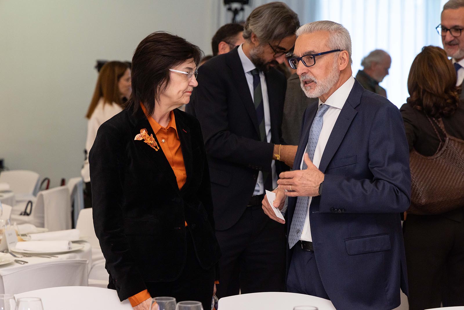 La presidenta de la CNMC, Cani Fernández, charla con el del CSN, Juan Carlos Lentijo. - FOTO: Dani Santamaría /></p><h3>Presencias y ausencias</h3>
<p>No faltó nadie, estaba prácticamente representado todo el sector. Desde el Ministerio, con <strong>Joan Groizard</strong> a la cabeza, hasta la Comisión Nacional de los Mercados y la Competencia (CNMC), con su presidenta <strong>Cani Fernández</strong> capitaneando el 'Dark Team'.</p>
<p>Por allí estaban directivos de todas las grandes empresas que forman Enerclub, entre ellos destacar a <strong>Reynés</strong>, <strong>Ruiz Tagle</strong>, <strong>Wetselaar</strong>, <strong>Vasconcelos</strong>, <strong>Casas</strong>, o el nuevo de Totalenergies que no he tenido tiempo de saberme bien su nombre, además de los presidentes o directores de las principales asociaciones energéticas, Aelec, APPA Renovables, Sedigas y muchas más y los amigos del Consejo de Seguridad Nuclear que se suelen prodigar poco por las fiestas.</p>
<p>Luego ya estábamos los plumillas y los del otro lado de la trinchera, de los equipos de Comunicación, donde todo es armonía.</p>
<h3>Susurros</h3>
<p>PUM. Sorpresa. "Mira, han venido", susurraban. No precisamente por el CSN, sino más bien por la CNMC. Se palpaba el mal rollo. Dientessss que diría la Pantoja. Saludos cordiales. Eso sí, respeto institucional y poco más. Pero eran el enemigo, pero sin la actuación de Gila.</p>
<p>No fue sóla Cani Fernández. Fue acompañada de su mano derecha en energía, <strong>Rocío Prieto</strong>, en estos momentos con el cartel puesto de <em>Wanted</em> como principal enemiga del sector. Lo que desconozco es si dan alguna recompensa por entregarla. La rumorología dice que está un poco cansada y que está buscando una salida fuera del regulador. <a href=